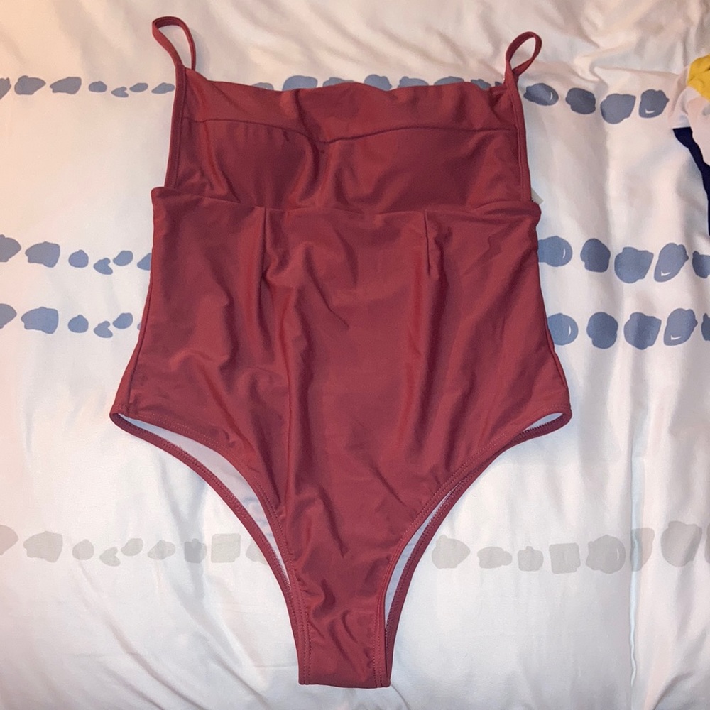 Never worn! Brand new clay covered one piece